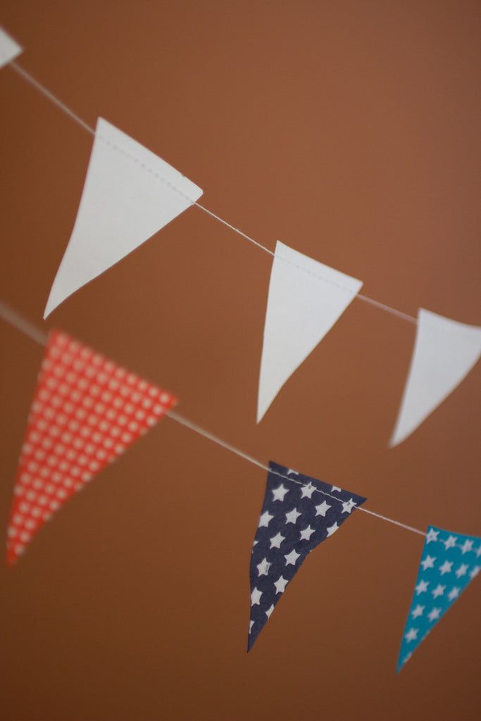 White Paper Flag Garland on a Wooden Spool - Bombay Mercantile