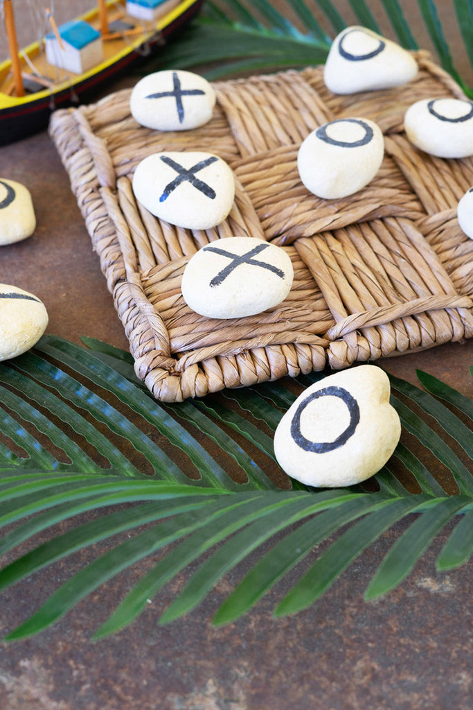 River rock tic-tac-toe on woven rush gameboard - Bombay Mercantile